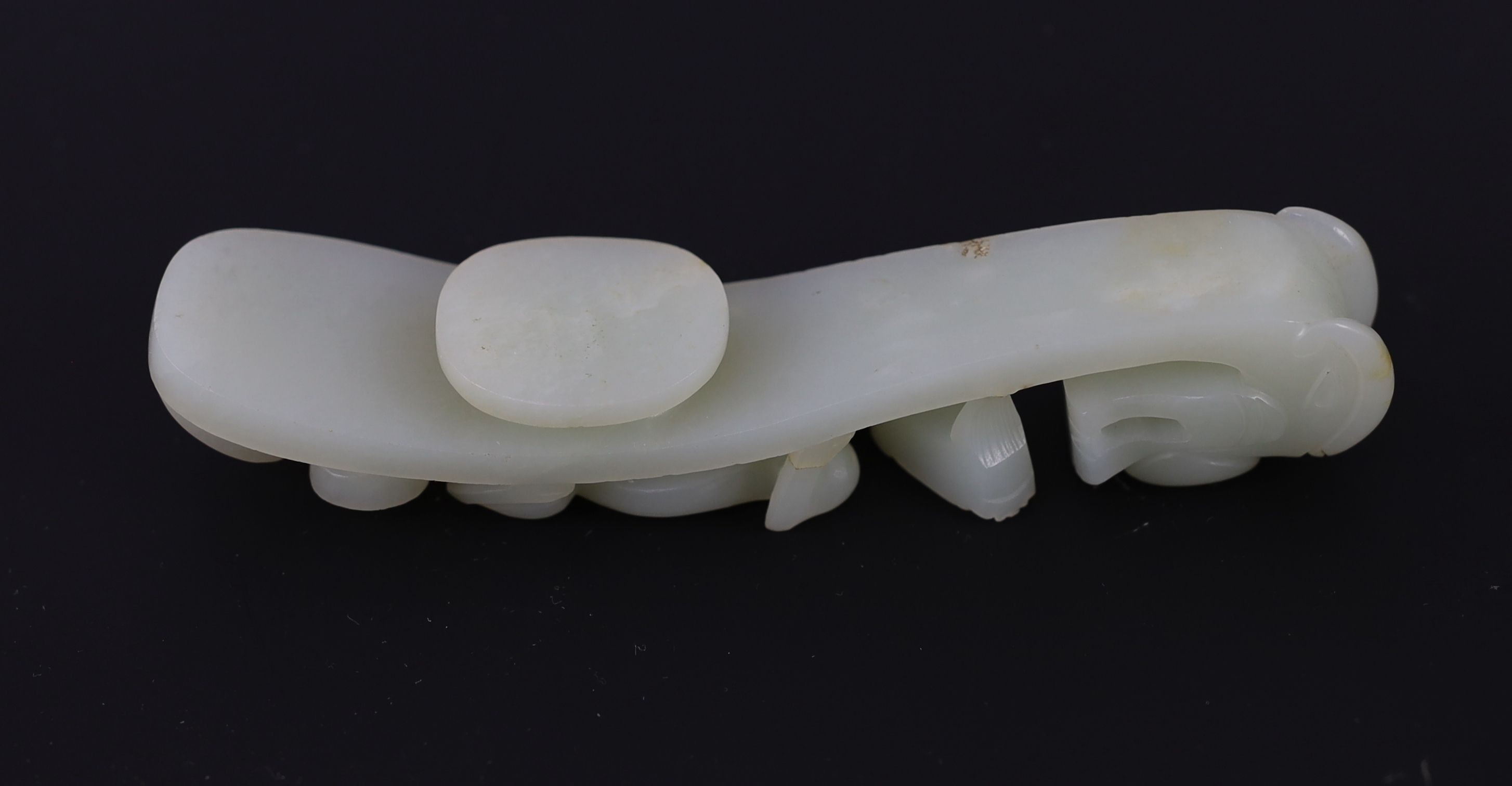 A Chinese pale celadon jade ‘dragon’ belt hook, 18th/19th century, 14.3cm